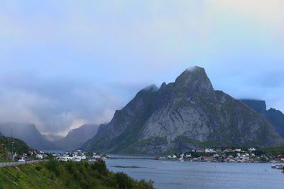 Scenic view of sea and mountains against sky