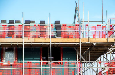 Low angle view of red building against sky