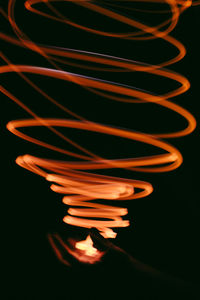 Close-up of spiral shaped fire at night