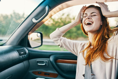 Young woman smiling in car