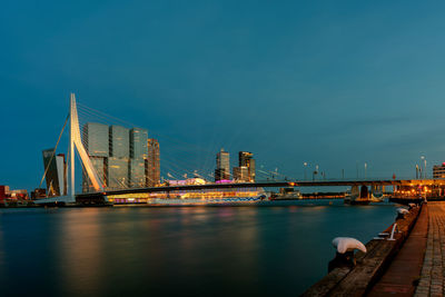 View of bridge over river at night