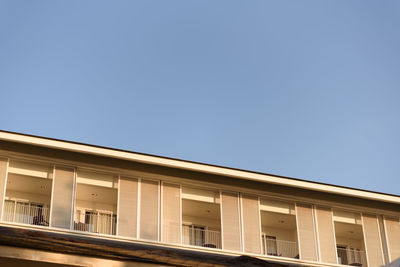 Low angle view of building against clear blue sky