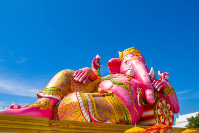 Low angle view of ganesha statue against sky