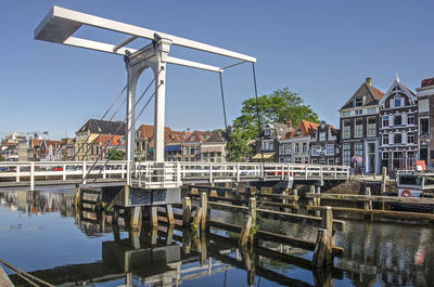 Houses and drawbridge reflecting in dutch canal