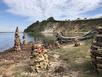 Stack of rocks on shore against sky