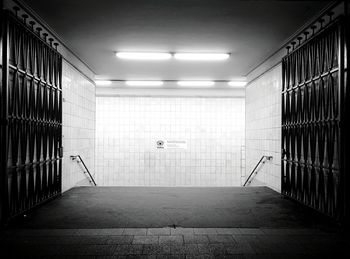 Open gates along tiled walls in subway