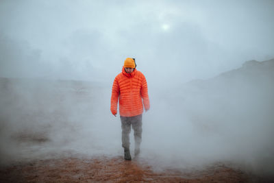 Man walking in winter in a fog day