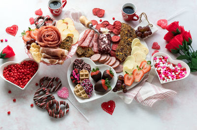 A valentine's charcuterie arrangement of various treats and snacks.