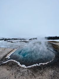 Scenic view of geyser against clear sky