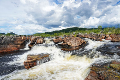 Scenic view of waterfall against sky