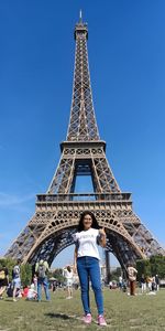 Portrait of woman standing against eiffel tower