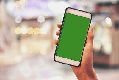 Close-up of hand holding mobile phone