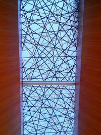 Low angle view of glass building against sky