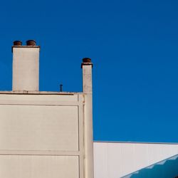 Low angle view of building against clear blue sky