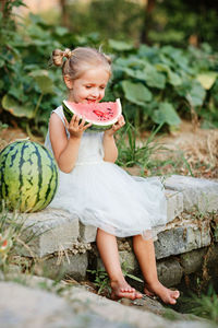 Portrait of cute girl sitting on field