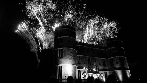 Low angle view of firework display at night