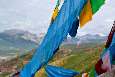 Prayer flags on mountain against sky