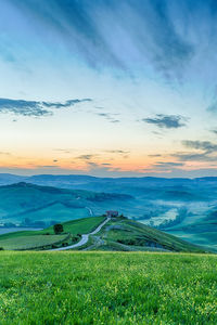 Landscape view in morning light with house on a hill in tuscany