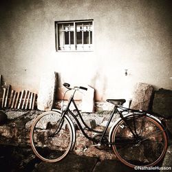 Bicycle parked in front of wall