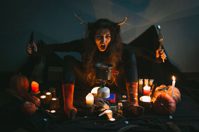 Close up female shaman with knife and spoon roaring portrait picture