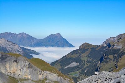 Scenic view of mountains against blue sky