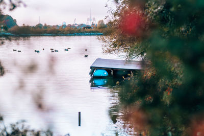 Boat in lake against trees