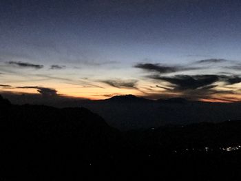 Scenic view of silhouette mountains against sky at sunset