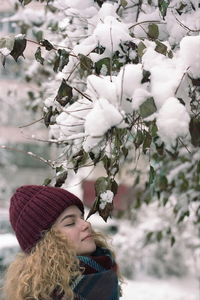 Portrait of young woman in park during winter