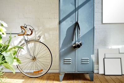 Bicycle by camera on cabinet