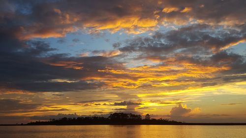 Scenic view of dramatic sky over sea during sunset