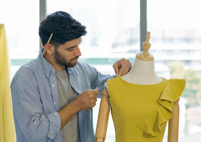 Fashion designer working on cloth