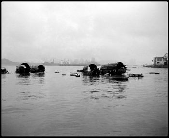 Boats in sea against sky