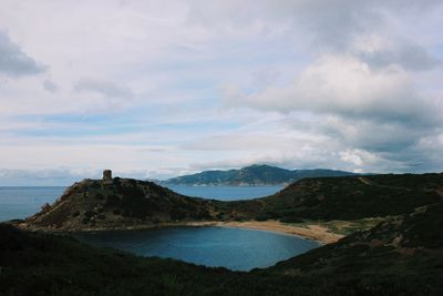 Scenic view of sea and mountains against sky