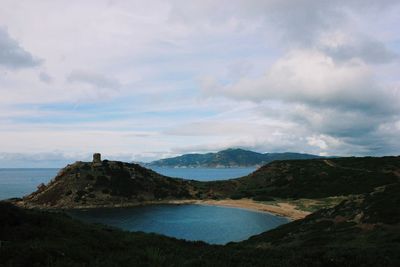 Scenic view of sea and mountains against sky