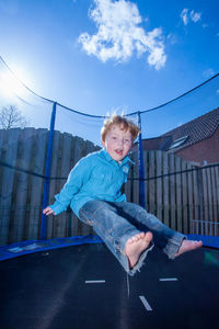 Portrait of boy jumping on trampoline