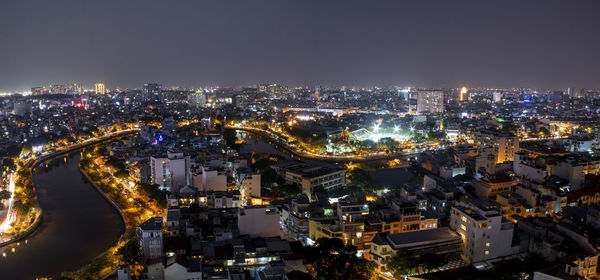 High angle view of city lit up at night