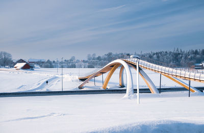 Snow covered bridge against sky