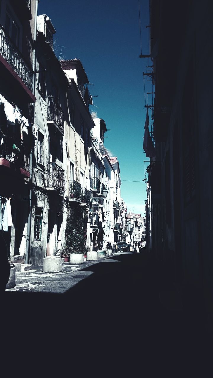 VIEW OF STREET IN CITY AGAINST CLEAR SKY