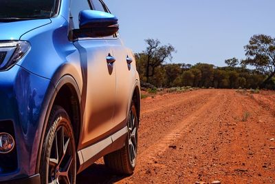 Close-up of car against blue sky