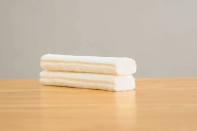 Close-up of stack on table against white background