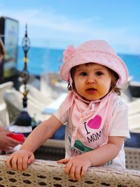 Portrait of cute girl sitting outdoors