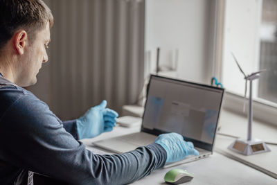 Businesswoman using laptop at home