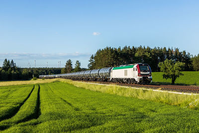 Train on field against sky