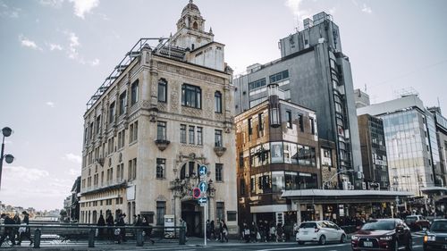 View of city street and buildings against sky