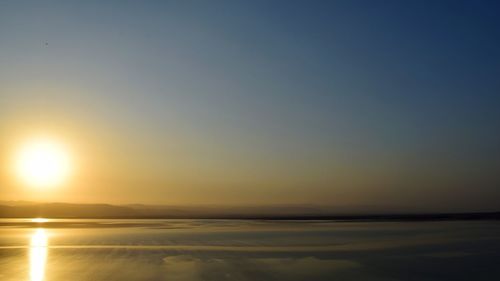 Scenic view of sea against clear sky during sunset