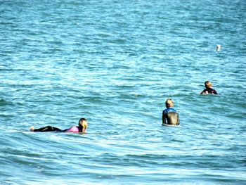 People swimming in sea