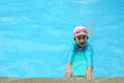 High angle portrait of girl swimming in pool