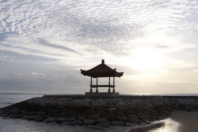 Lifeguard hut on beach against sky