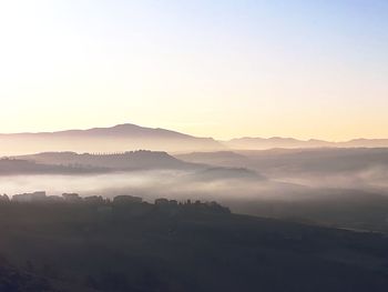 Scenic view of mountains against sky during sunset