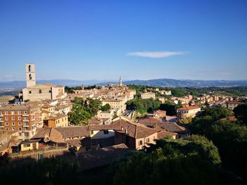 View of townscape against blue sky